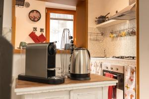 a kitchen with a coffee maker on a counter at 5 stelle Dimora storica in Valle D'Itria con WIFI in Turi