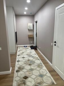 an empty hallway with a rug on the floor at Rams in Almaty