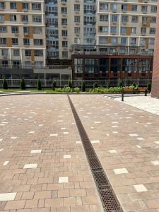 a brick parking lot with buildings in the background at Rams in Almaty