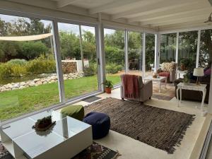 a living room with a lot of windows at Tree House in McGregor