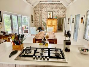 a kitchen with a stove top in the middle of a room at Tree House in McGregor