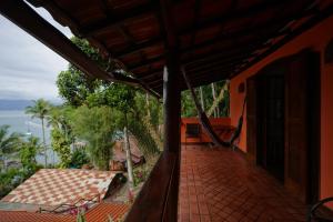 an outside view of a house with a porch at Casa da Ilha & SPA in Abraão