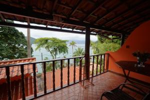 a balcony with a view of the ocean at Casa da Ilha & SPA in Abraão