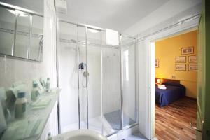 a bathroom with a shower and a toilet and a bedroom at Hotel San Lorenzo in Florence