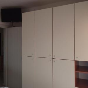 a white closet with a television on top of it at Dolce Relax - Sottomarina in Sottomarina