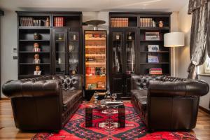a living room with two leather couches and a table at Marmont Heritage Hotel in Split