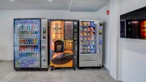 three soda machines are lined up in a store at Motel 6 Highland CA San Bernardino East in Highland