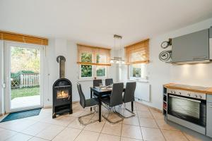 a kitchen and dining room with a table and a fireplace at FH Seidenstücker in Breege