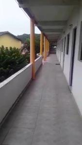 an empty hallway of a building with columns at Flats Encantador in Rio das Ostras