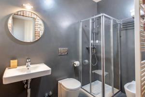 a bathroom with a shower and a toilet and a sink at Locanda Camia Restaurant and Rooms in Novello +26 photos