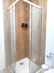 a shower with a glass enclosure in a bathroom at Casa Lucía - Caminito del rey in Valle de Abdalagís +23 photos