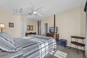a bedroom with a bed and a ceiling fan at Legacy Villa 504 in Gulfport +15 photos