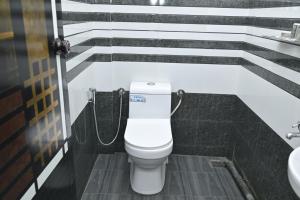 a bathroom with a toilet and a sink at Nirupama,Hotel Aluva 700 Mtr From Aluva Railway Station in Alwaye +34 photos