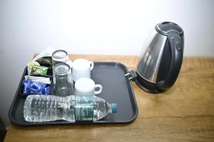 a plastic container with water bottles on a table at Nirupama,Hotel Aluva 700 Mtr From Aluva Railway Station in Alwaye