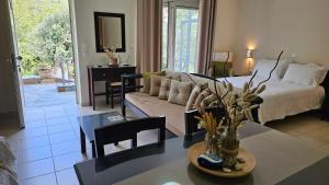 a living room with a couch and a table at Naiades Villas in Karistos
