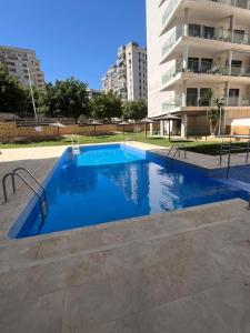 a swimming pool in the middle of a building at Aloha Benidorm in Cala de Finestrat