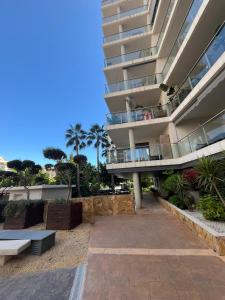 an apartment building with a balcony and a patio at Aloha Benidorm in Cala de Finestrat