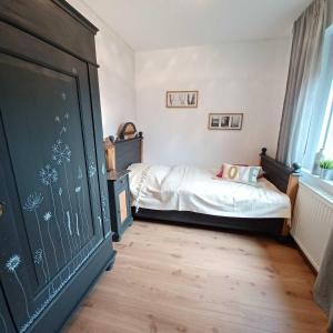 a bedroom with a bed and a large chalkboard at Ferienwohnung Stadt-Land-Fluss in Bad Salzuflen +66 photos