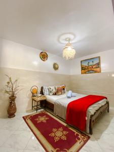 a bedroom with a bed with a red blanket at Dallas Private Surf Apartment in Agadir