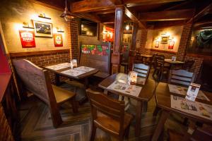 a restaurant with tables and chairs in a room at Hotel Europa in Kalisz
