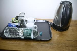a bottle of water in a tray on a table at Nirupama,Hotel Aluva 700 Mtr From Aluva Railway Station in Alwaye
