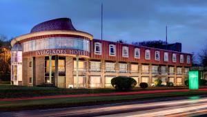 a large building with a sign on the front of it at Everglades Hotel in Derry Londonderry