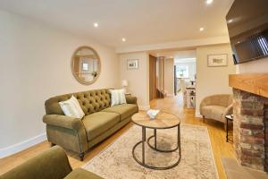 a living room with a couch and a table at Host & Stay - Ginger Bread Cottage in Stokesley