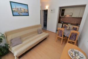 a living room with a couch and a table at Slanica Murter MATE in Murter