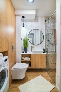 a bathroom with a washing machine and a sink at Apartament Mono Lux in Zamość