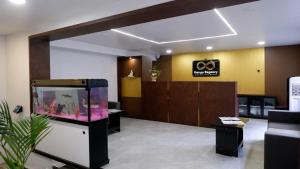a lobby with a fish tank in a room at Ganga Regency in Solapur