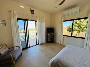 a bedroom with a bed and a sliding glass door at Casa Corazon - Private Home w Mtn & Ocean Views! in El Pescadero +47 photos