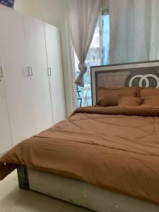 a bedroom with a large bed with a window at city towers ajman in Ajman 
