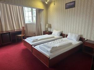 Postel nebo postele na pokoji v ubytování Hotel Amadeus