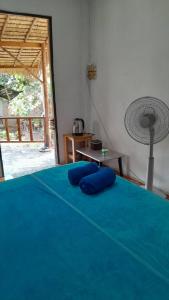 una camera con un letto con cuscini blu sopra di Bamboo Hut Resort and Restaurant a Ko Man Nai