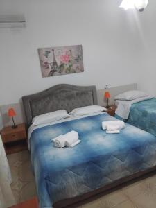 a bedroom with a bed with two towels on it at Torre di Amalfi - holiday house in Amalfi