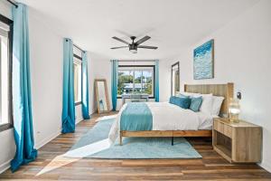 a bedroom with a bed and a ceiling fan at Heated Pool Grill Fire Pit & Cold Plunge Sleeps 8! in West Palm Beach +78 photos