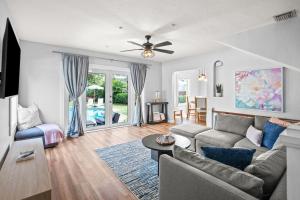 a living room with a couch and a table at Heated Pool Grill Fire Pit & Cold Plunge Sleeps 8! in West Palm Beach