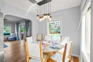 a dining room with a table and chairs at Heated Pool Grill Fire Pit & Cold Plunge Sleeps 8! in West Palm Beach