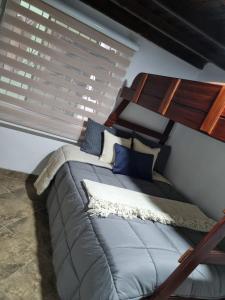 a bed sitting in a room with a window at Pedacito de cielo in San Antonio de Prado
