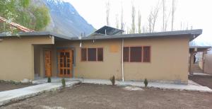a small house in front of a mountain at Valhalla Guest House Skardu in Skardu