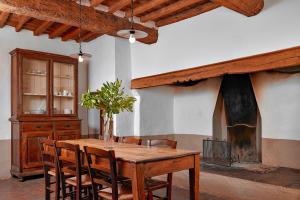 a dining room with a wooden table and chairs at Agriturismo Canonica in Greve in Chianti