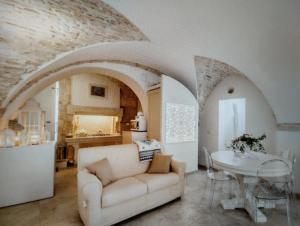 a living room with a couch and a table at La Grazia dei fiori in Martina Franca