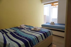 a bedroom with two beds and a window with towels at Apartment Stepen in Trstenik