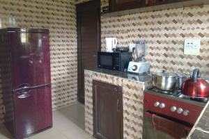 a kitchen with a red stove and a microwave at 2 Bed-Sleeps 4-Free Parking-AirCon in Benin City +31 photos