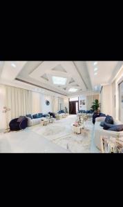 a large living room with couches and tables at The SEVEN in Al Ain