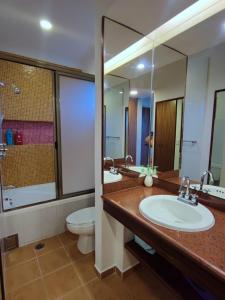 a bathroom with two sinks and a toilet and a mirror at Casa Estrella de Mar in Cancún +47 photos