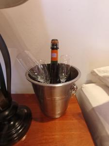 a bucket with a bottle of champagne and wine glasses at Desert Wings in San Pedro de Atacama