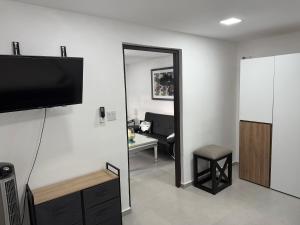 a living room with a flat screen tv on a wall at Casa Dushi Apartment in Oranjestad