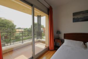 a bedroom with a bed and a large window at Beach House Castelldefels in Castelldefels +44 photos