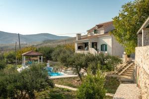 a villa with a swimming pool and a house at Villa Pax in Kastel Stafilic